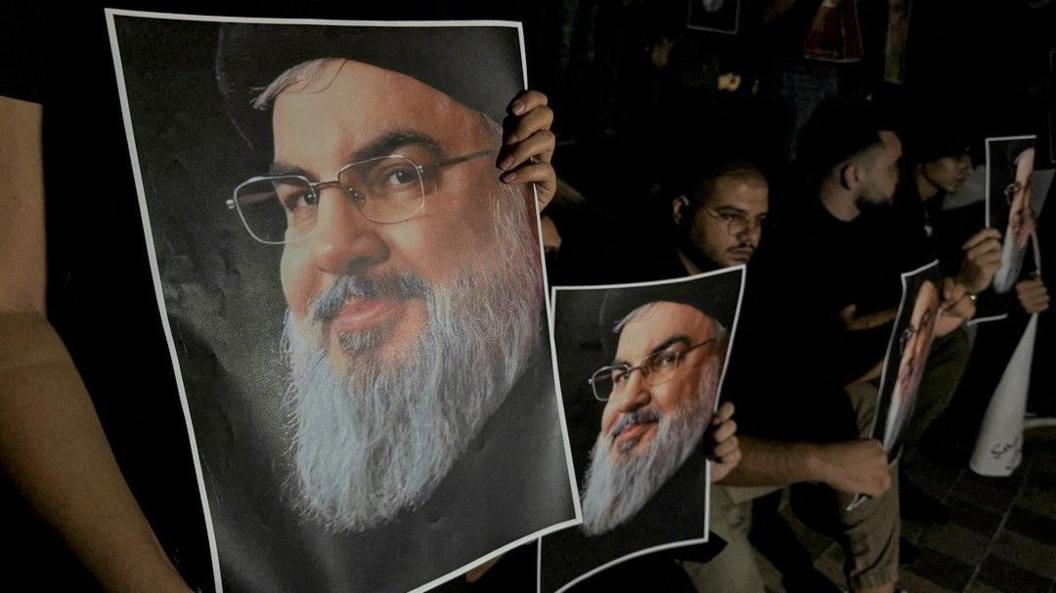 Supporters of Lebanon's Hezbollah leader Hassan Nasrallah carry his pictures as they gather in Sidon, Lebanon, following his killing