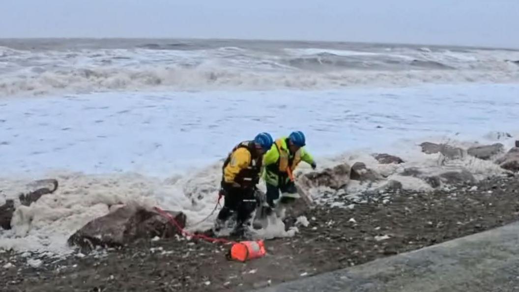 Coastguards bringing the training dummy ashore at Cleveleys in Lancashire.