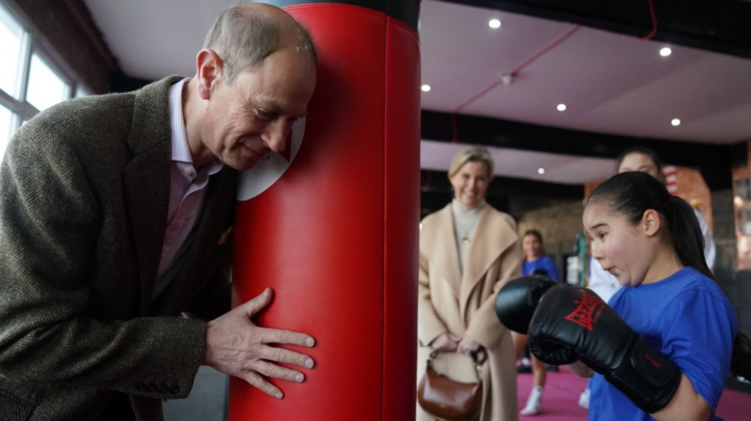 The Duke of Edinburgh holding a punchbag