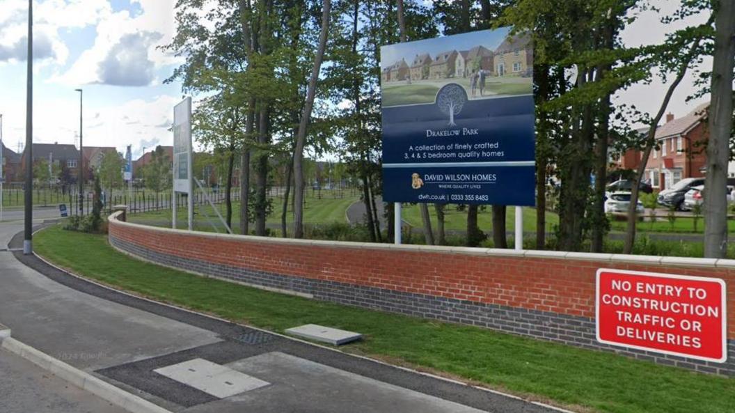 General view of Drakelow Park housing estate with boards advertising the estate to passing drivers