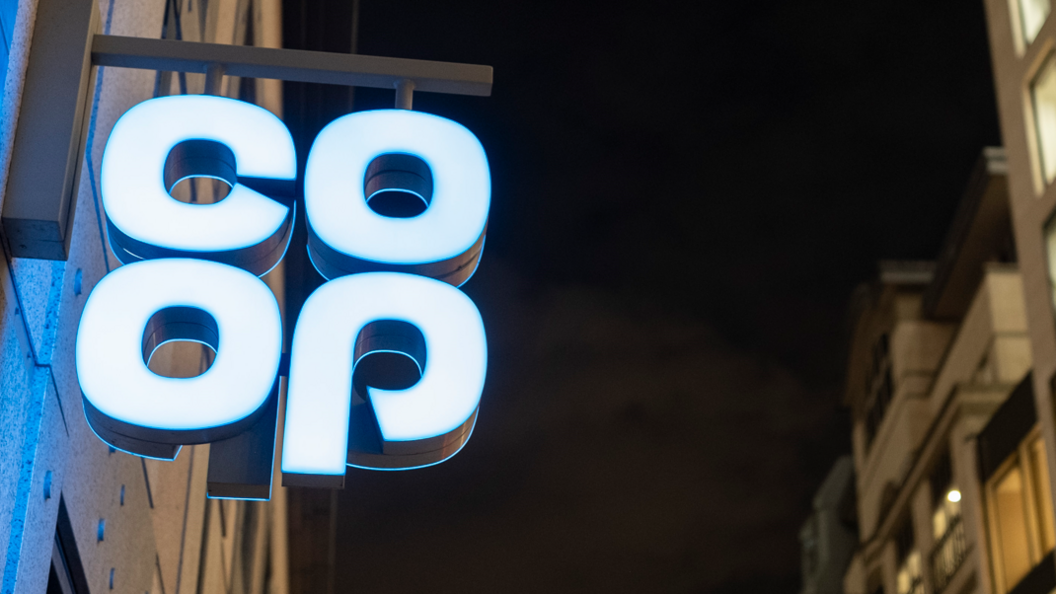 Co-op sign lit up at night in London