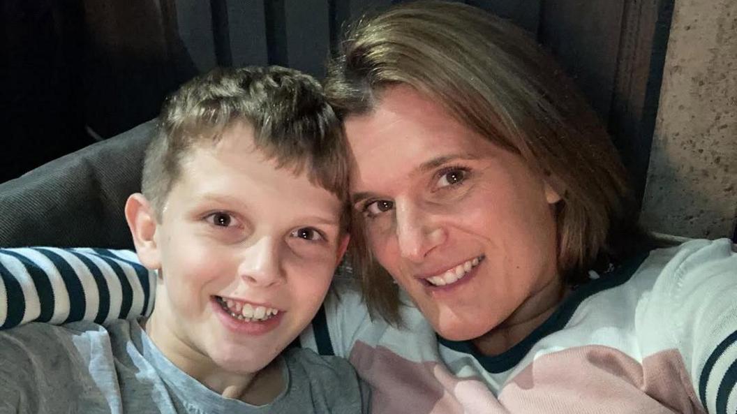 Undated family handout photo of Ellen Roome with her 14-year-old son Jools Sweeney, who was discovered unconscious in his bedroom at home in April 2022. They are both smiling at the camera and she has one arm wrapped around his shoulder