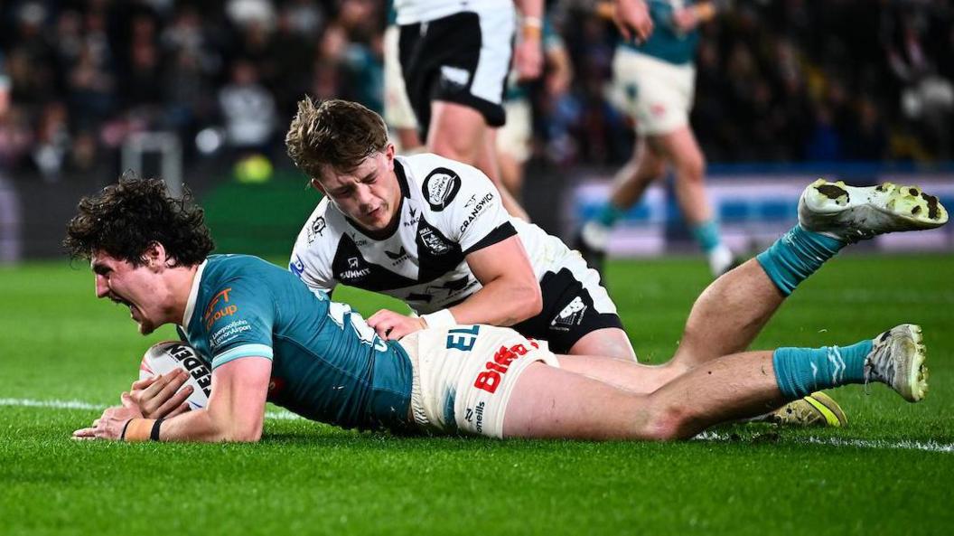 Jake Davies roars with delight after diving over the line to ground the ball for his first Super League try