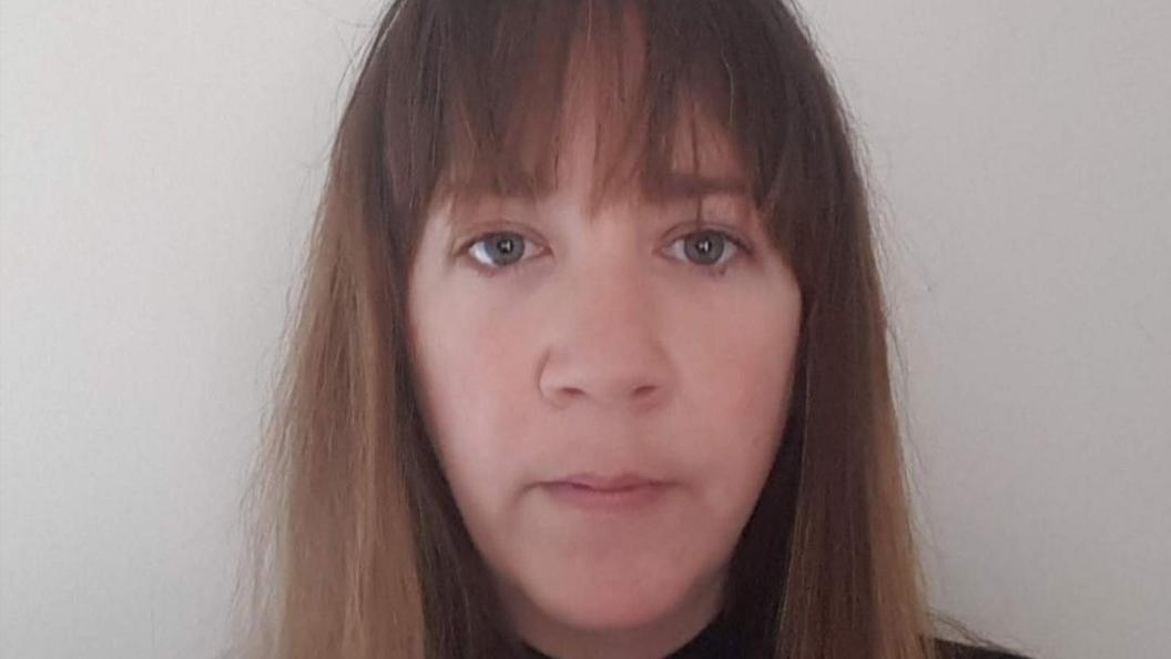 A headshot of Mrs Witherington. She is facing the camera. She has brown hair with a fringe and blue-green eyes. She is not smiling with a neutral face.