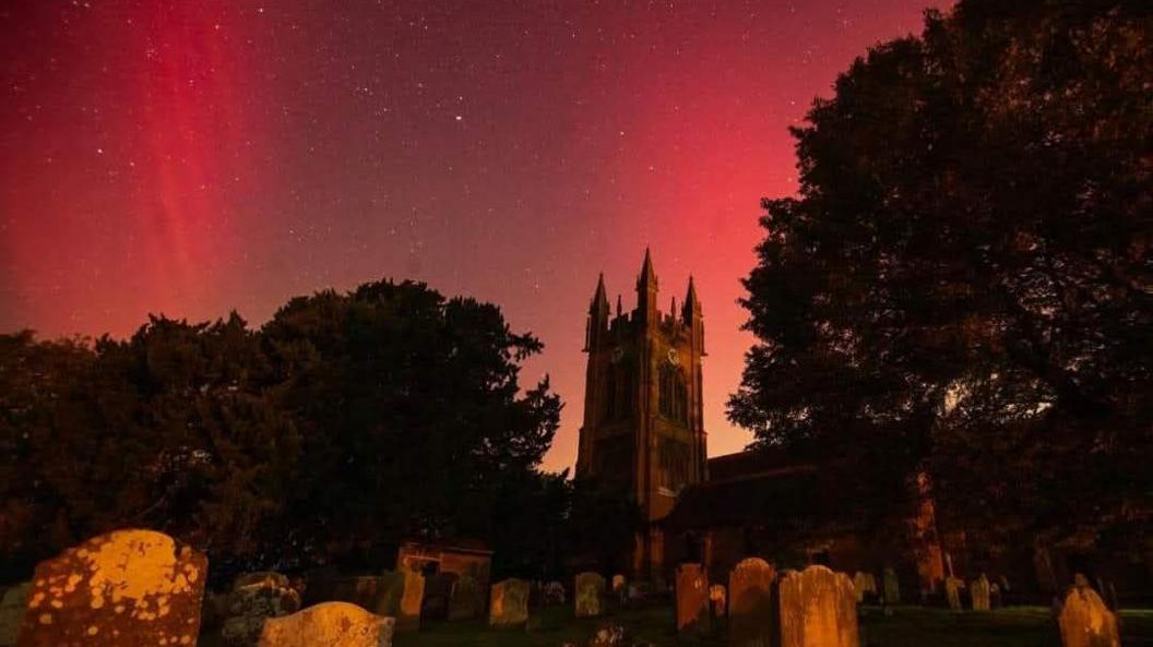 The Northern Lights illuminate the sky in red behind St Mary's Church in Enville, near Stourbridge.