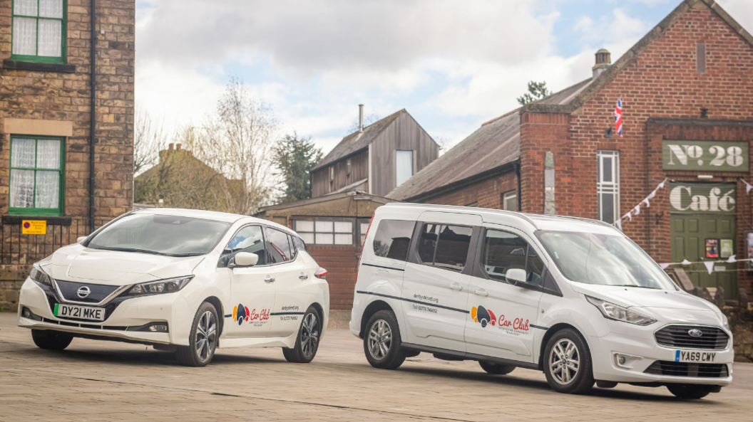 One family sized car and one wheelchair friendly van in a car park with Derby Community Transport branding