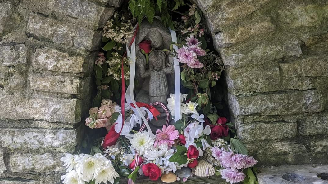 The Mother and Child statue dressed in ribbons and flowers