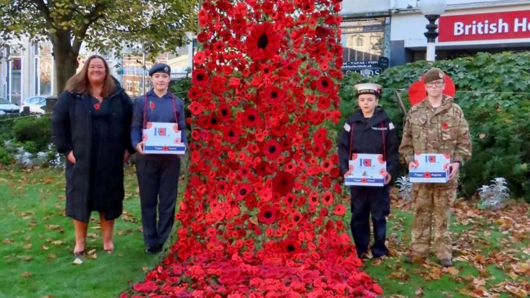 Sefton council leader, councillor Marion Atkinson to the right, with poppy volunteers from the Royal British Legion, stand next to the poppy drape