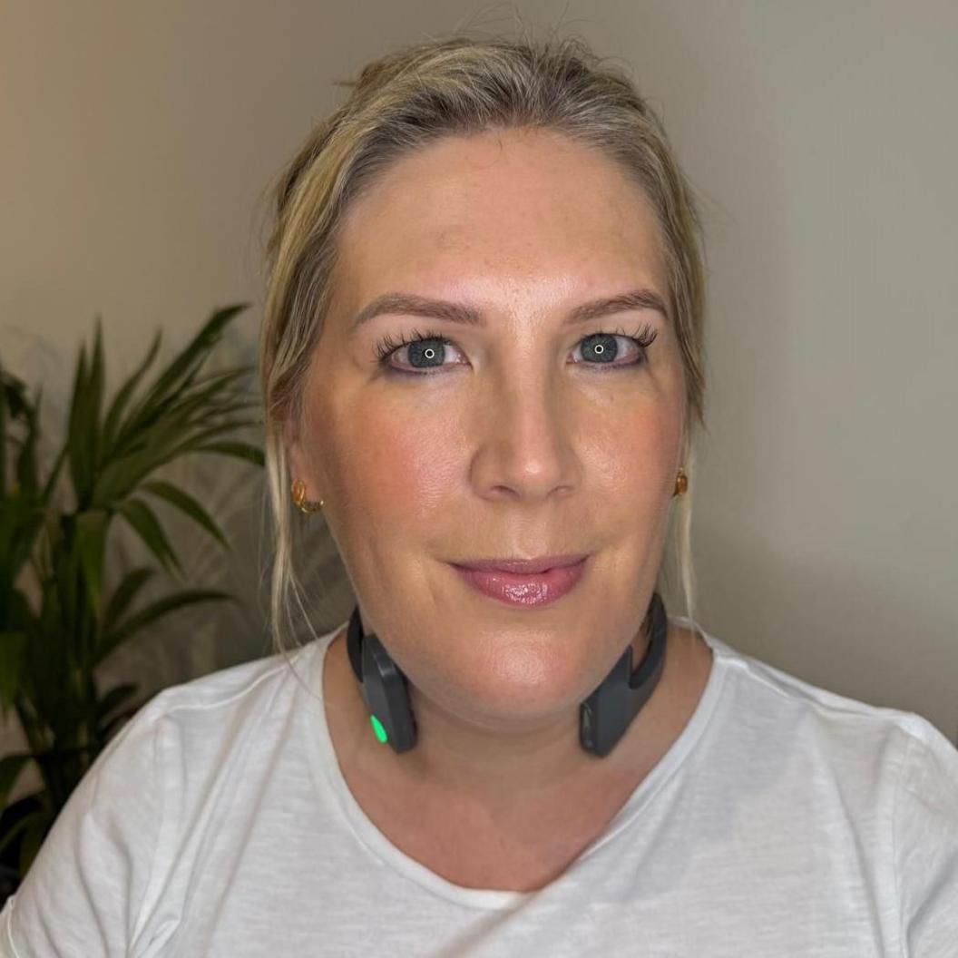 Lucy Lambert wearing stimulation device on her neck