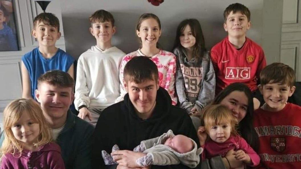 Jenna and Kenny's children with their newborn