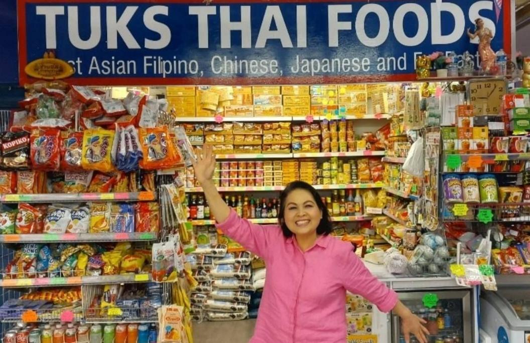 Tuk outside her stall, with food and spices