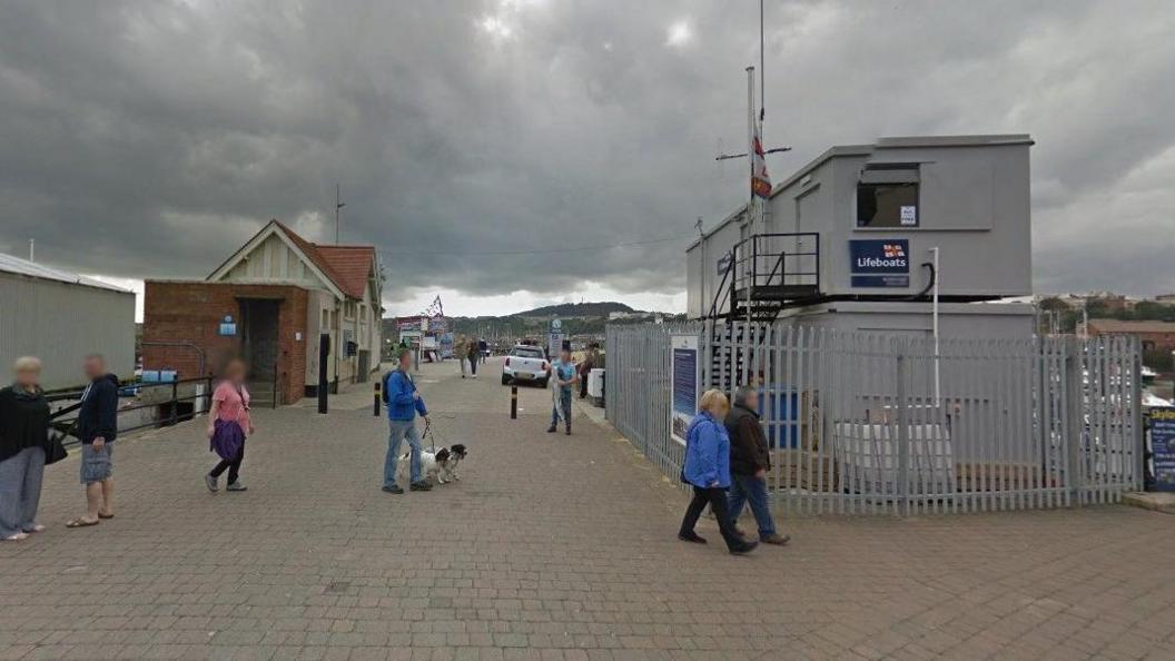 Image of Vincent's Pier in Scarborough, North Yorkshire with various people milling about