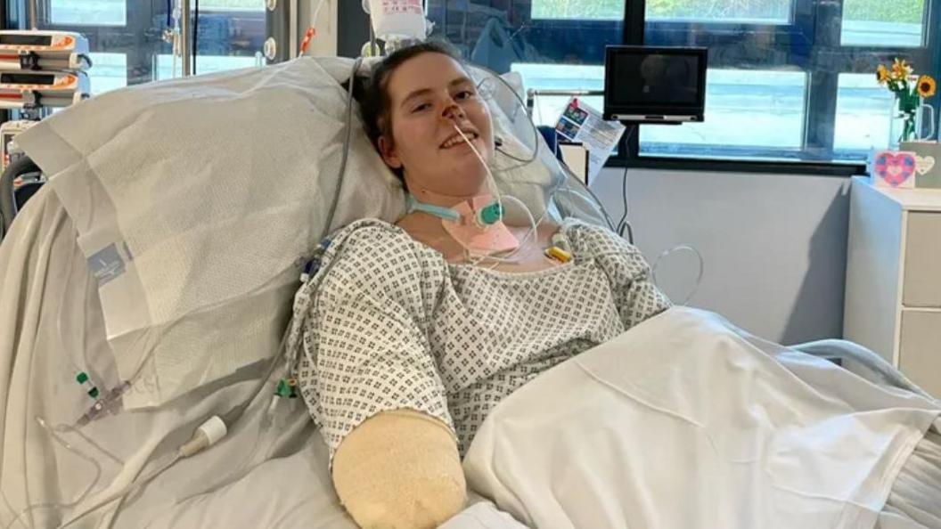 Quadruple amputee Lily McGarry smiles from her hospital bed.