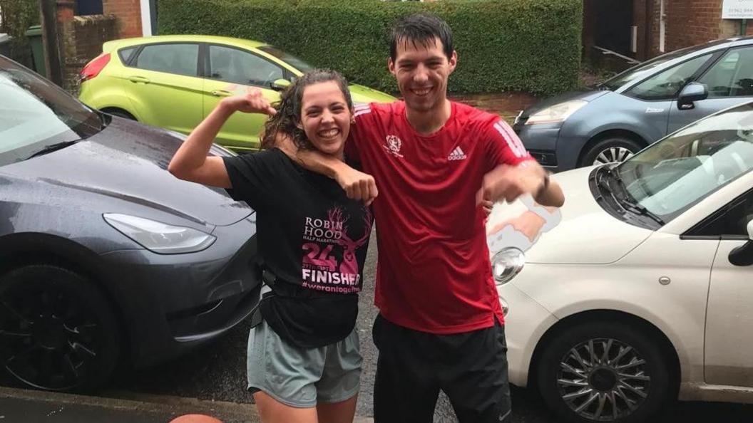 Róisín and Samwere on the pavement after the race looking wet from the rain.