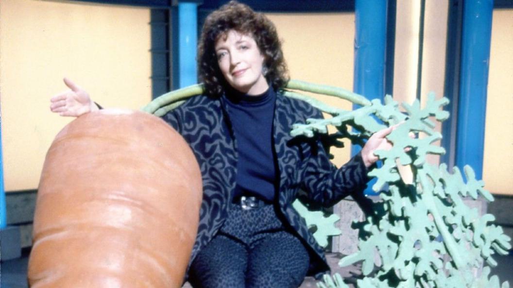 Judith Hann with a giant carrot