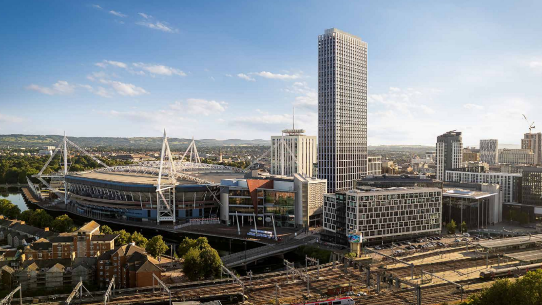 Visualisation of the 50-storey planned proposal in Central Sqaure, Cardiff city centre. A large sky scraper can be seen next to the Principality stadium in daylight, along with Cardiff's skyline and railway lines.