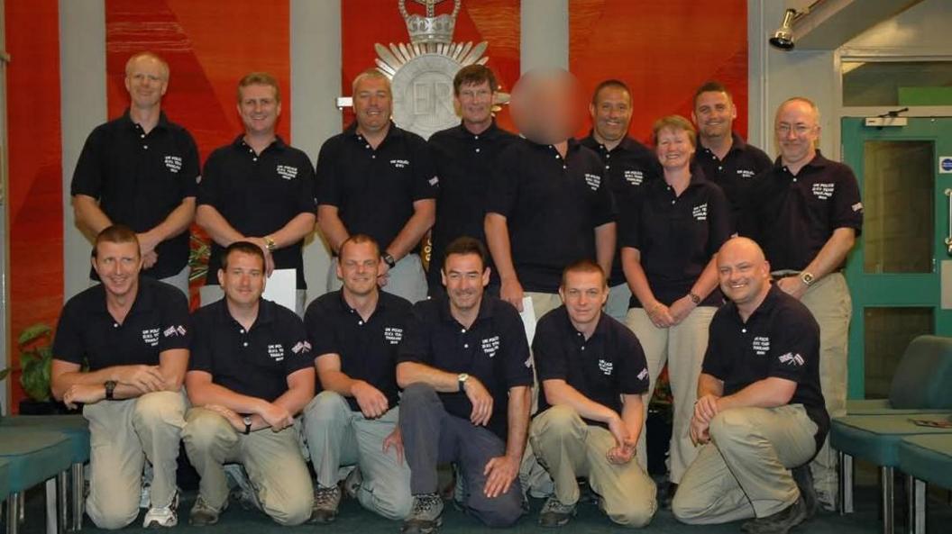 14 men and 1 woman from Gwent police, posing for a picture, in two rows