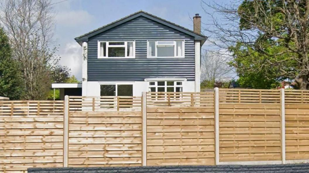 A house in Chepstow surrounded by a wooden fence