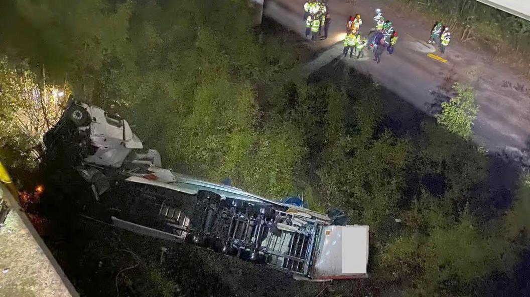 The overturned lorry pictured from above after it fell off the Thelwall Viaduct