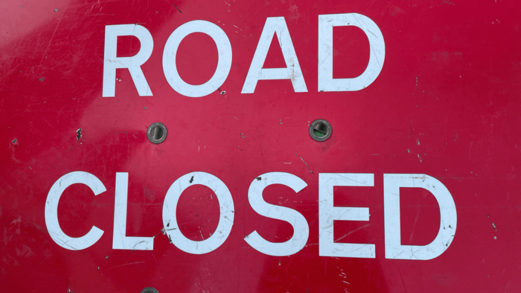 A red sign that reads "road closed"