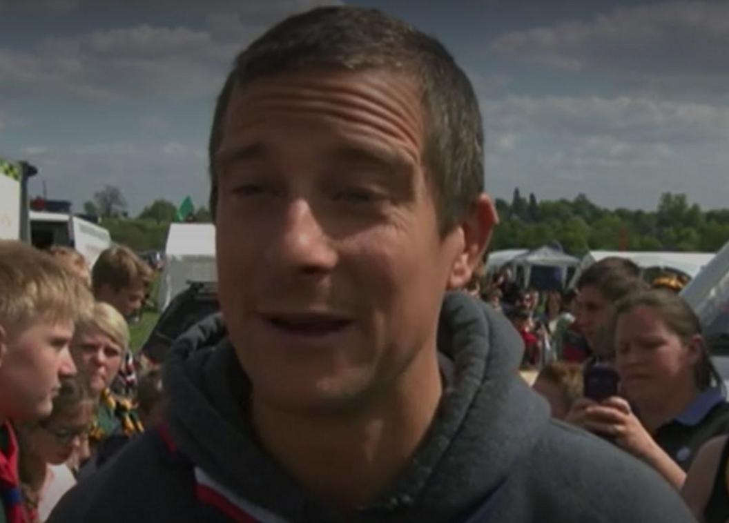 Bear Grylls with short fair hair surrounded by scouts