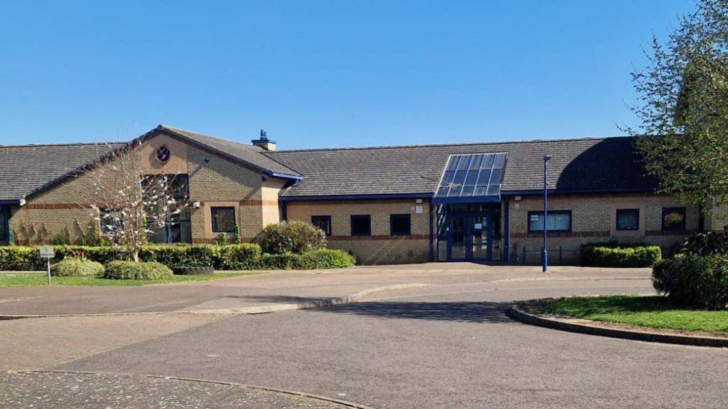 NeneGate School, a single-story pale brick building.