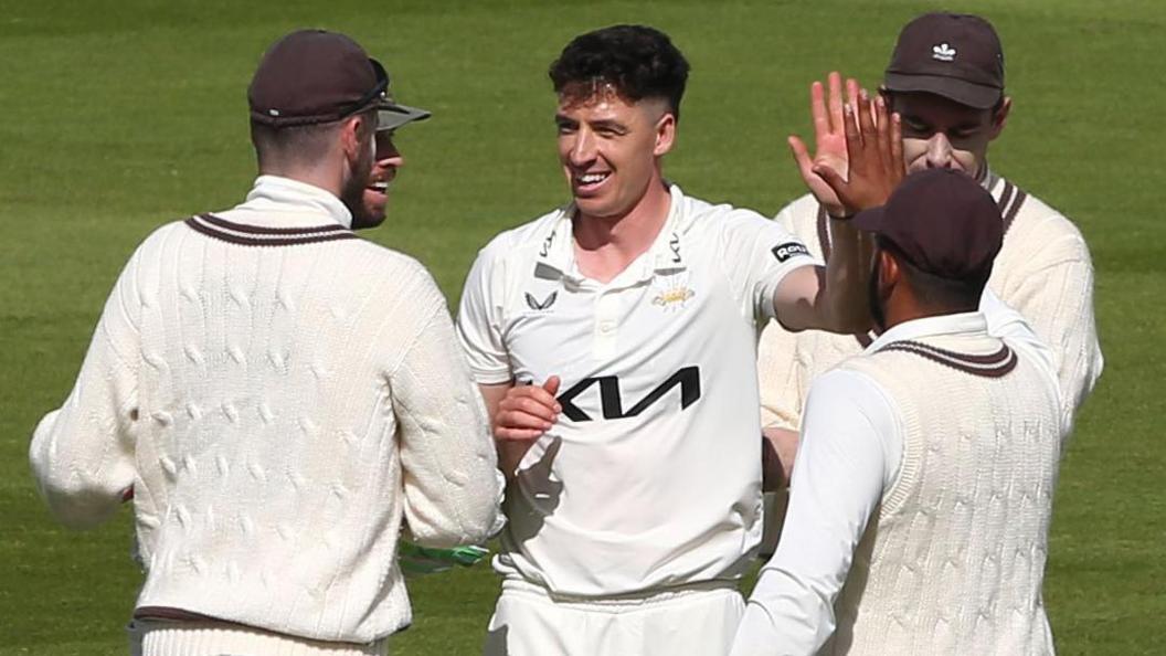 Matt Fisher takes a wicket for Surrey
