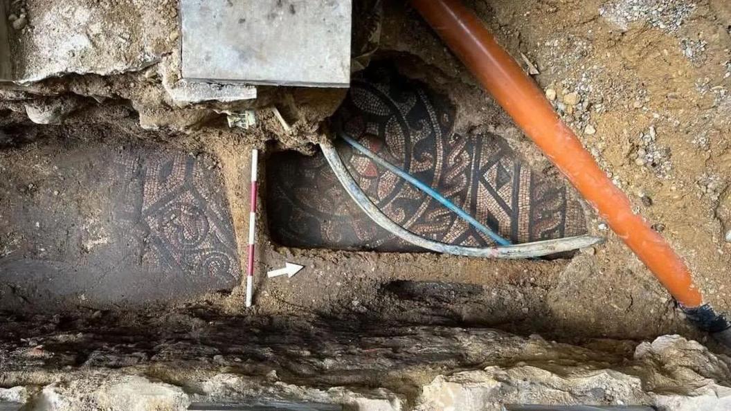 A Roman piece of artwork displayed under concrete.