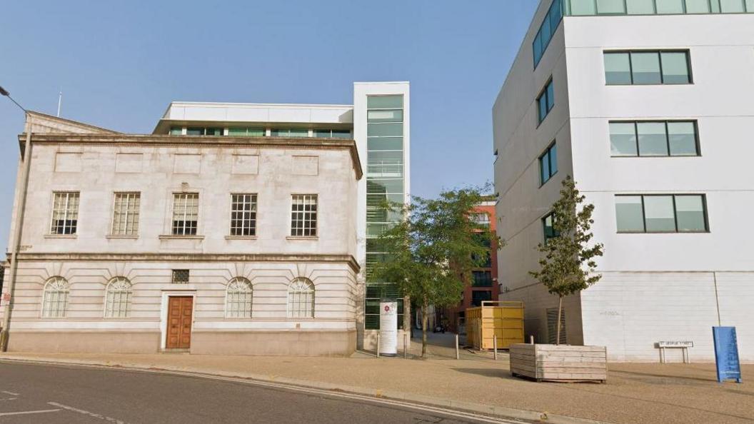 Streetview image of Colton Square, a paved area formed by a mix of modern and traditional buildings