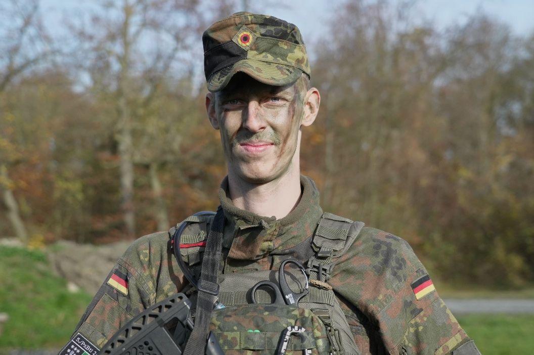 A young man wearing military fatigues