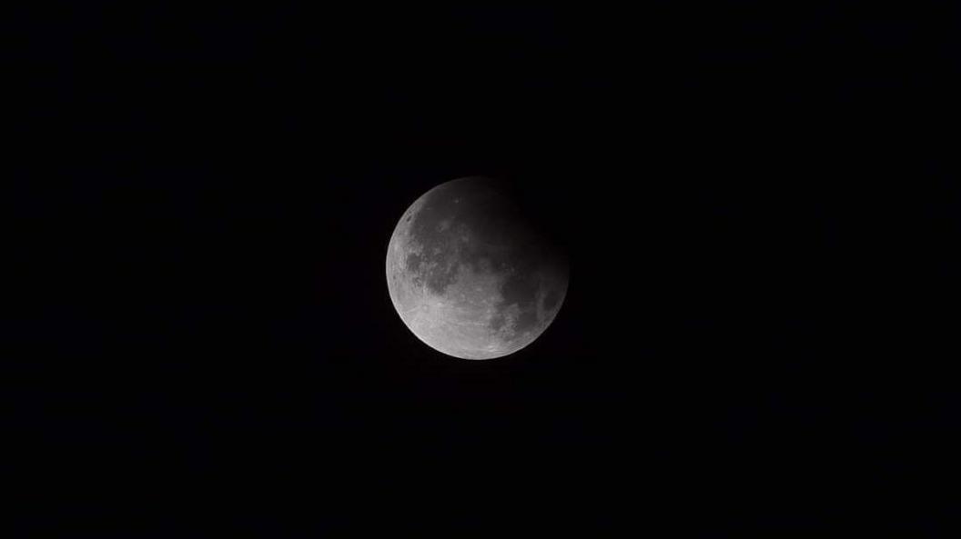 The moon against a black night sky over Scotland