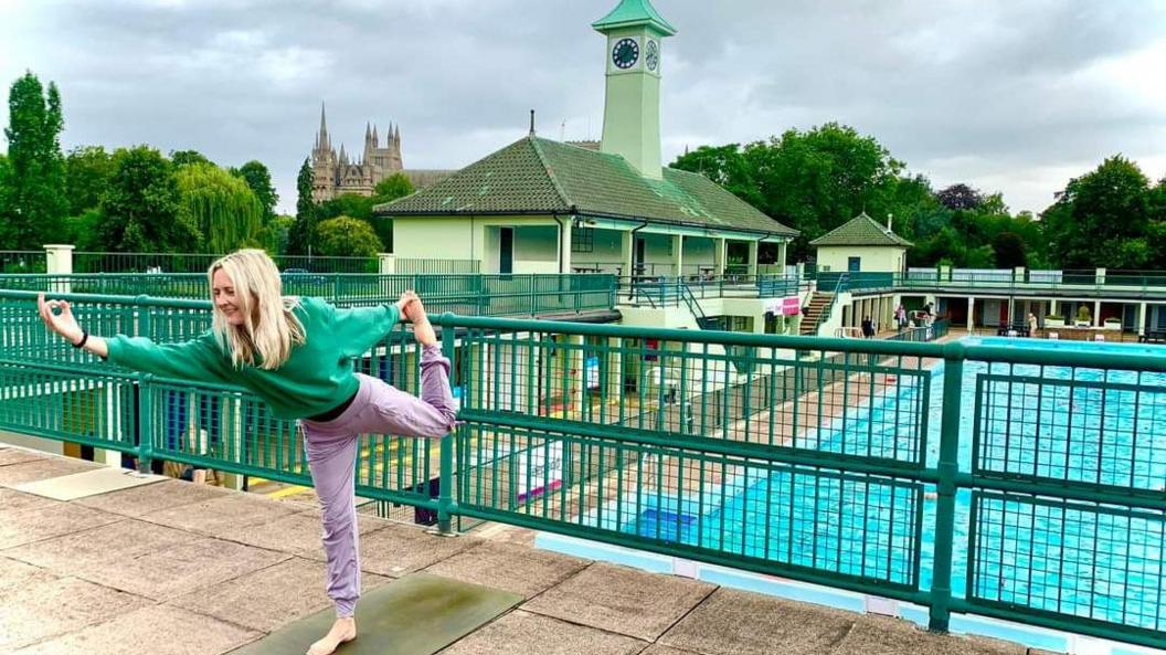 Yoga teacher posing in front of the Lido 