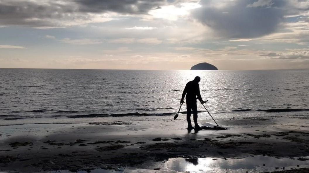 Bernard Harris metal detecting on Girvan Beach.