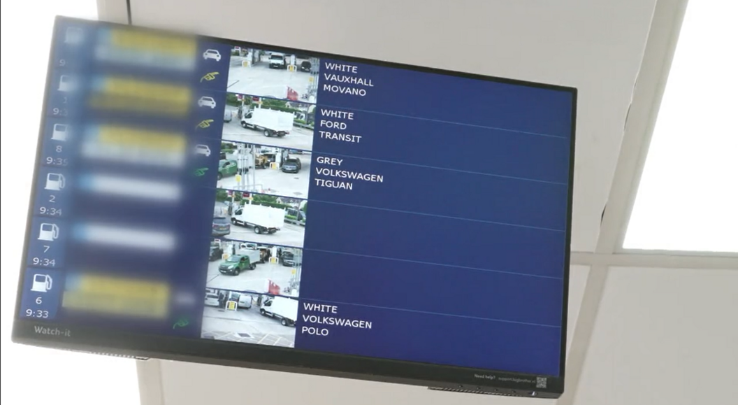 A screen showing video footage of vehicles at fuel pumps at the service station