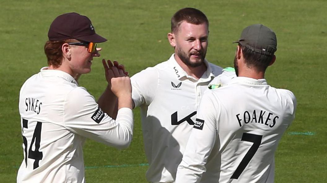 Gus Atkinson takes a wicket for Surrey