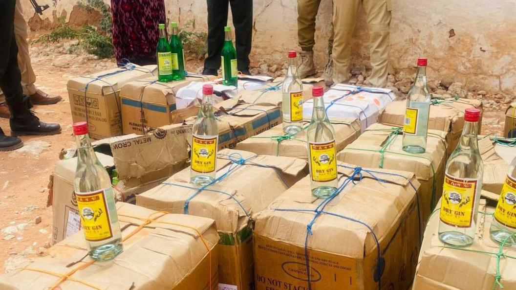 Bottles of alcohol on top of boxes