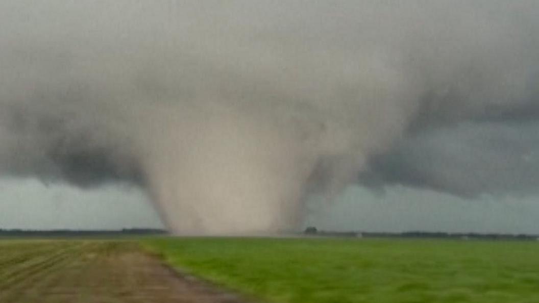 A large, wide tornado in a field