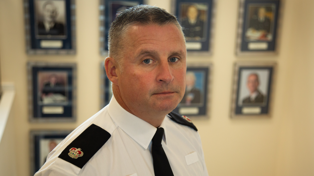 A middle-aged policeman, Det Supt Gareth Morgan, looks at the camera in his uniform