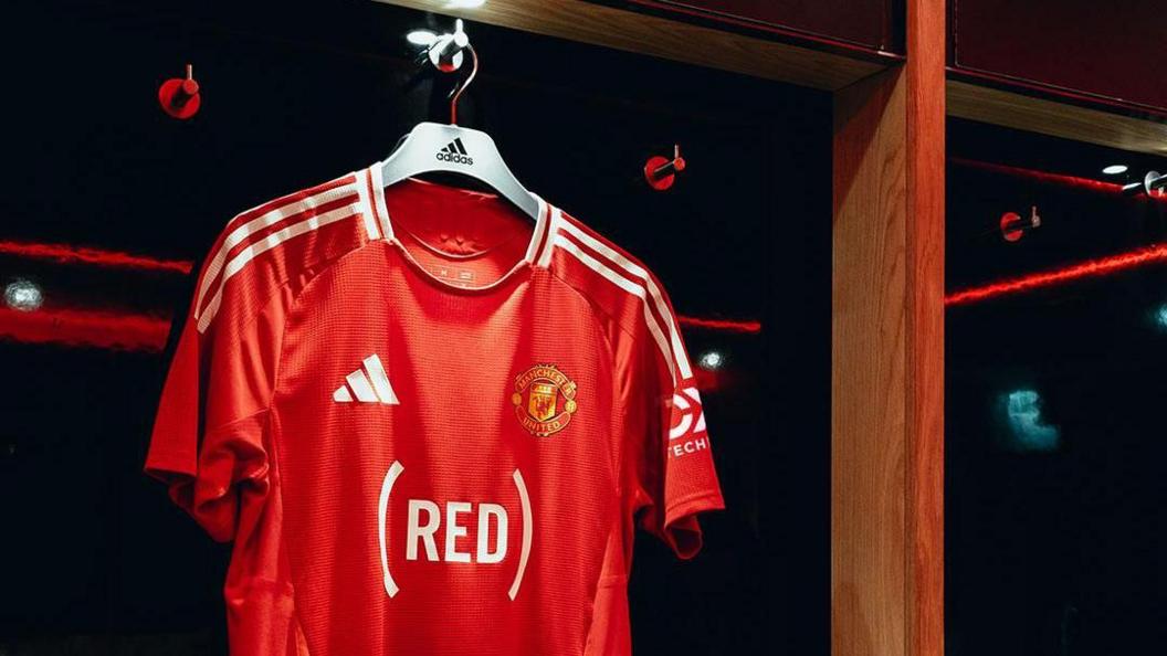 Manchester United's home shirt with the (Red) logo