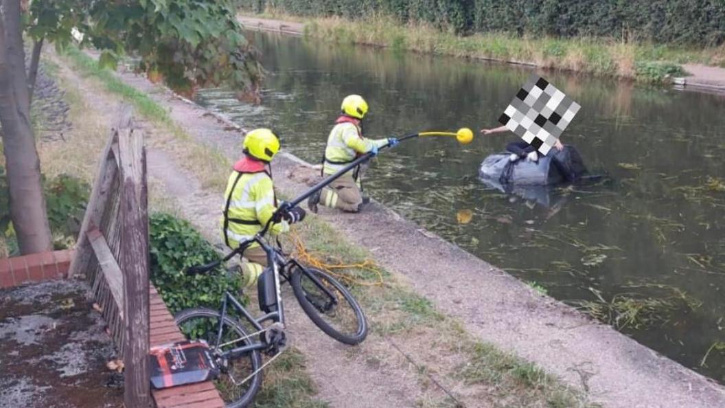 Firefighters help the child reach safety