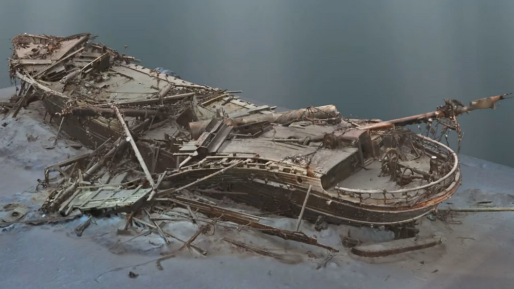 A CGI of the Endurance shipwreck. A long thin wooden boat at the bottom of the sea, seemingly flattened or crushed.