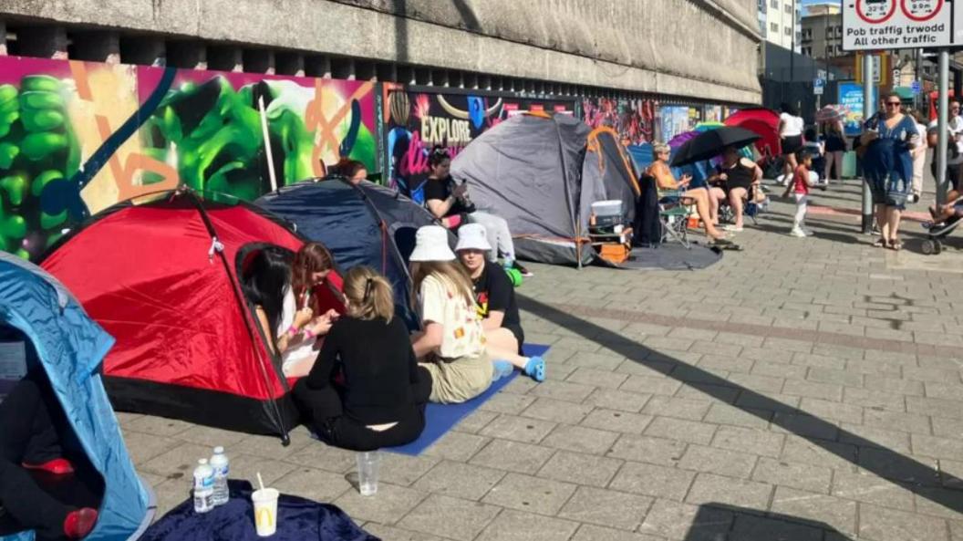 people camping near concert venue