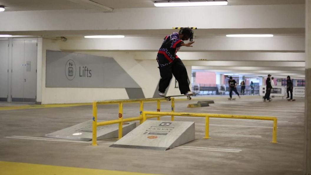 A man skateboarding in Cabot Circus car park 