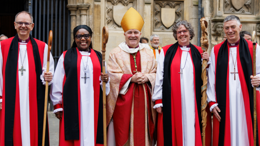 Bishop of York Stephen Cottrell is standing in his robes outside Canterbury Cathedral between other bishops in red robes who have been consecrated