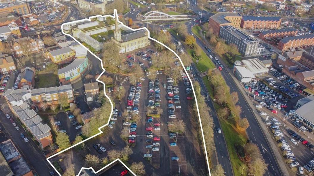 An aerial view of a car park, with the car park outlined in white.