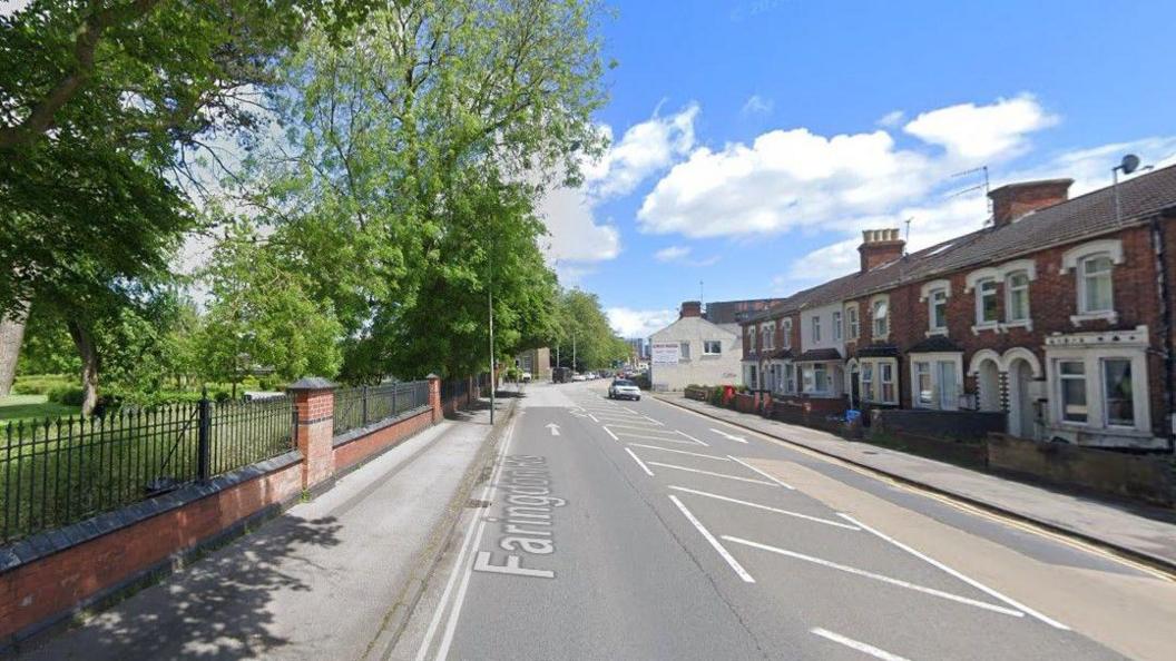 A Google Streetview image of Faringdon Road. It has Victorian terraced houses on the right side, mostly built of red brick, and a park with large green trees on the left behind a brick wall with an iron fence. 