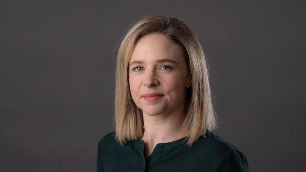 Professor Laura McGowan, facing the camera, with blonde hair and dark top.
