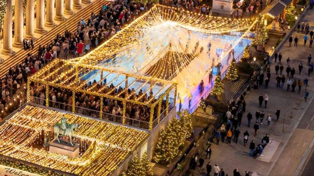 A GCI image of how St George's Plateau might look at night with the new market in 2026. You can see the existing statues and grand columns of St George's Hall. In the foreground is an ice rink festooned with fairy lights and crowds of people filling the plateau. 