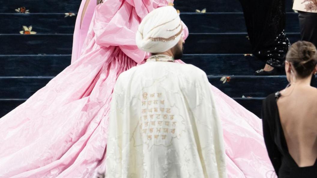 The back of Diljit Dosanjh's outfit at the Met Gala which is a cape that has the map of Punjab and Punjabi syllables embroidered into it.