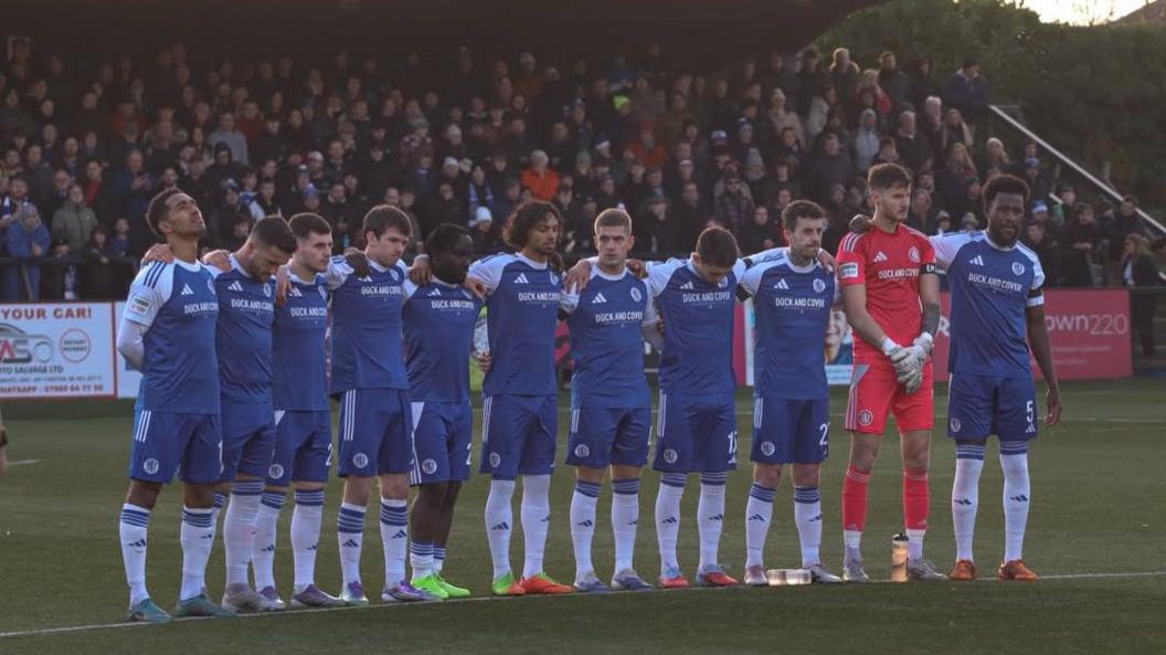 Macclesfield players hold a minute's silence for Ethan McLeod